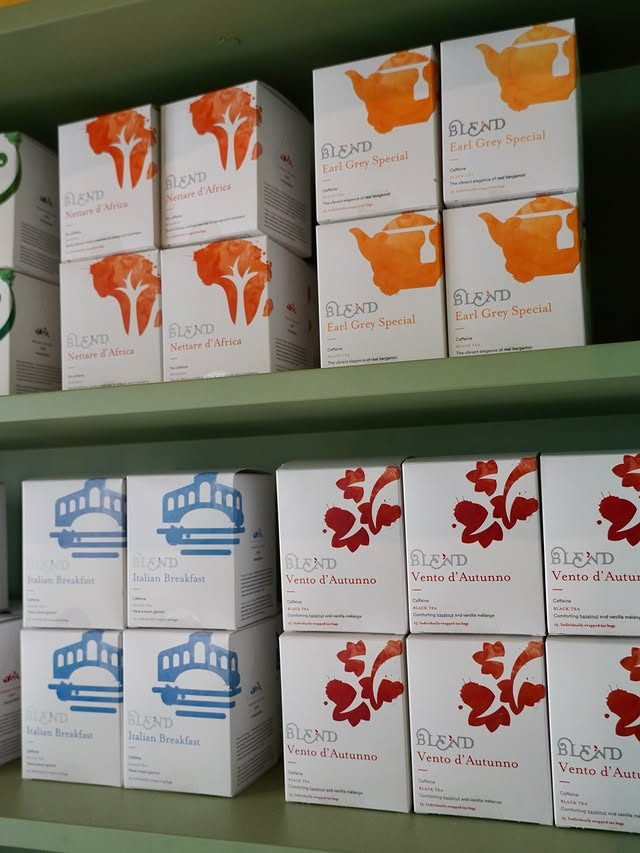 Shelves of Blend tea boxes, each with a painted motif.